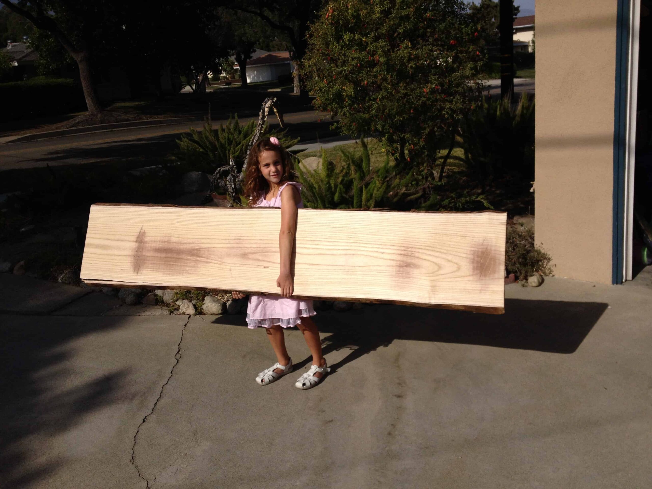 wood shop student carrying wood